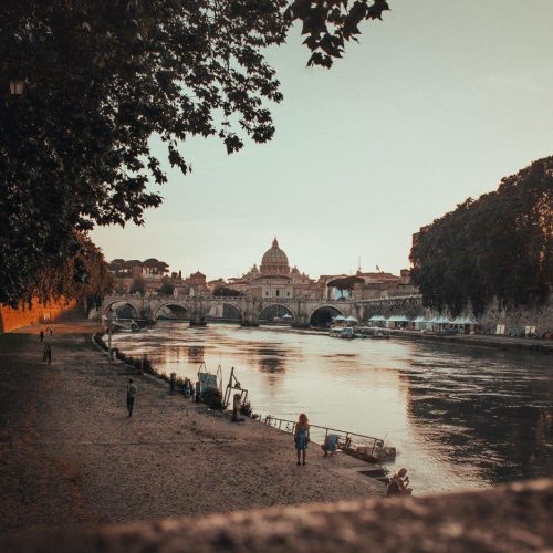 beautiful-shot-black-concrete-pathway-beside-body-waterin-rome-italy-during-sunset